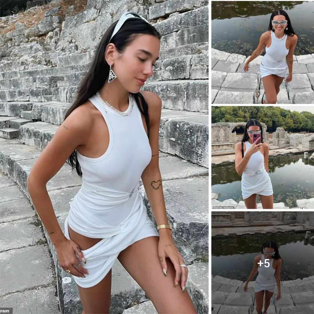 Dua Lipa stepping out in style! The singer looks amazing in a skimpy white mini-dress and futuristic matching shades as she visits ruins in Albania during her family trip